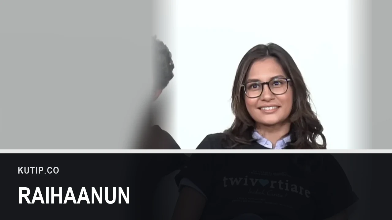 Aktris Raihaanun berkacamata tersenyum dalam sebuah wawancara, ditempatkan di sisi kanan bingkai dengan latar buram dari foto yang sama, dengan nama Raihaanun tertulis pada palang di bagian bawah gambar